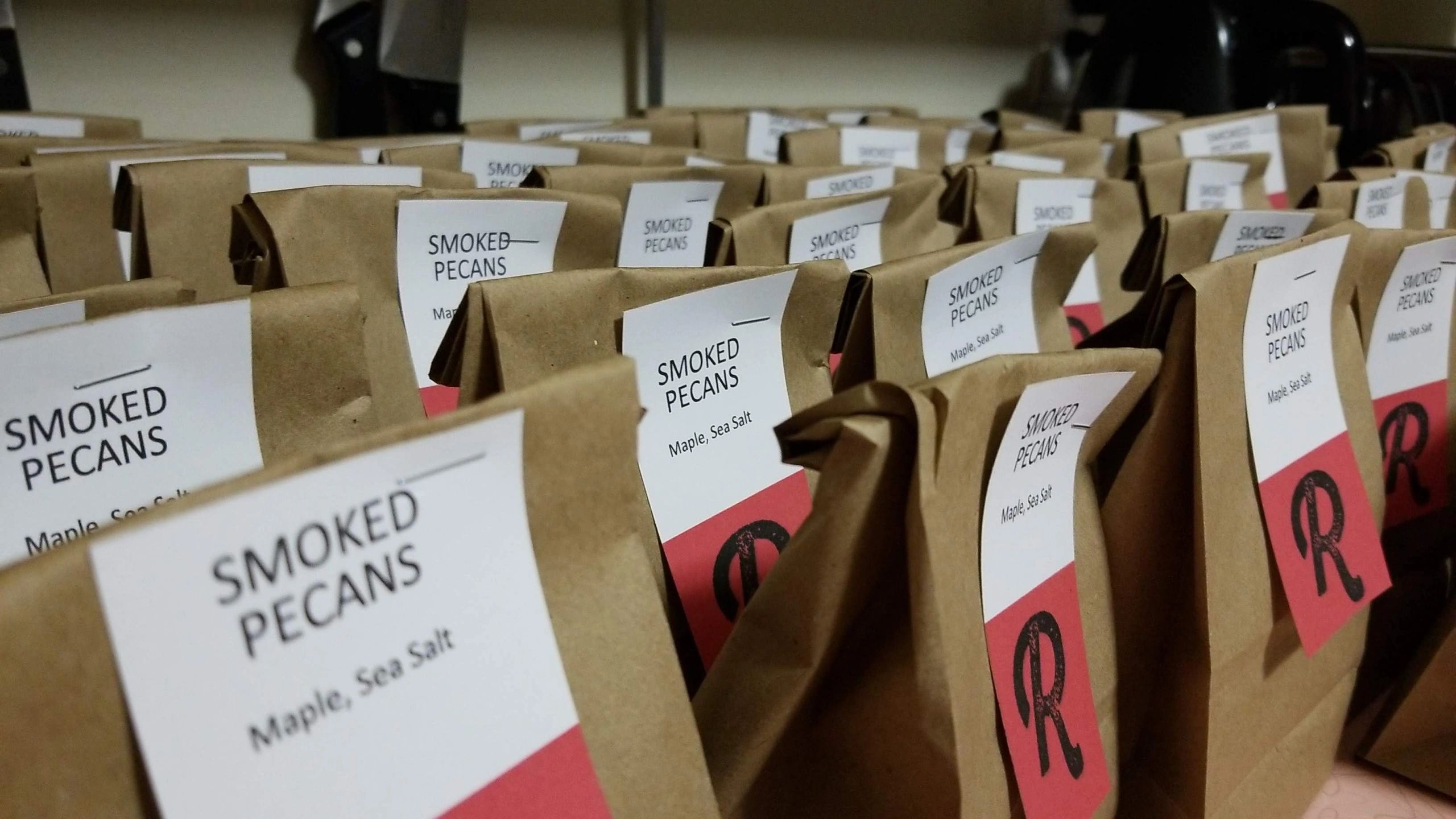Smoked Pecans in kraft paper bags